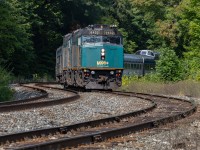 Trundling through the siding for a meet with CN107. 21 glorious cars of stainless tell trail. Life is good; traditions matter.