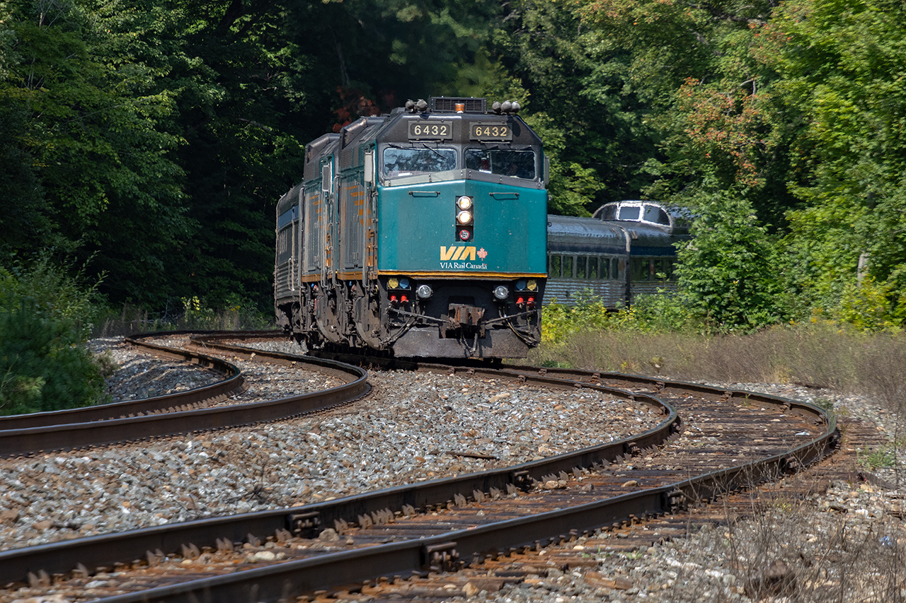 Trundling through the siding for a meet with CN107. 21 glorious cars of stainless tell trail. Life is good; traditions matter.