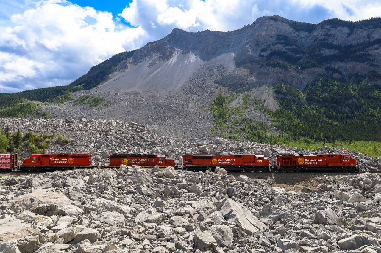 In the early morning hours of April 29, 1903 the peaceful mountain town of Frank, Alberta was awakened by the thunderous sound of a rock slide on Turtle Mountain. Within 100 seconds, 110 million tons of rock fell into the valley below at speeds approaching 70 miles an hour. When it was all said and done, over 90 people had lost their lives and 3 square kilometers of the valley were buried by rock averaging 46ft deep, with some places being buried 150ft deep. At the time, this was the largest recorded land slide in Canadian History and the CP mainline was buried for approximately 1.2 miles. Within 3 weeks the railway had blasted a path through and re-opened the Crowsnest Sub. The eastern end of Frank, Alberta was devastated by the slide and the town was relocated out of the path of Turtle Mountain.  Fast forward 119 years after the devastating slide, we see CP 219 with CP 8000, CP 7046, CP 5792 and CP 5973, with CN 3905 on the tailend, climbing through the debris field at Frank Slife.