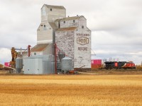 X 11651 26 highballs past the nicest wooden elevator left on the Wainwright Sub, at Reford, Saskatchewan. 