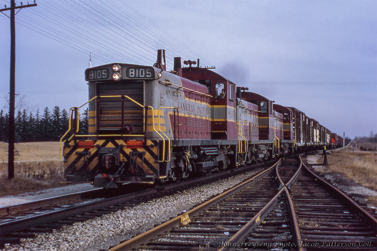 London-bound Extra 8105 west cruises through Killean, a few miles east of Galt.  Having just crossed Side Road 10 South, the train is seen passing the original location of Killean station and siding at mile 51.97 Galt Sub. Originally named Leslie until renaming in the early 1920s, the 1879 station was demolished during the mid-1960s and the siding moved west to mile 55.4.John Freyseng Photo, Jacob Patterson Collection slide.