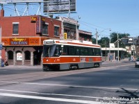 Two year old TTC CLRV 4160 heads southbound on Dundas Street West crossing Bloor Street West, having just departed <a href=http://www.railpictures.ca/?attachment_id=51391><b>Dundas West Subway Station</b></a> in the background on an eastbound Route 505 Dundas run on this sunny afternoon in Toronto. The streetcar is seen passing the Range Tavern at the northwest corner (in more recent times, this whole block of stores had been closed since the late 2000's pending redevelopment into condos). 4160 would be retired in October 2019 as the remaining fleet was being replaced by new Bombardier articulated LFLRV cars.
<br><br>
<i>William (Bill) Madden photo, Dan Dell'Unto collection slide.</i>