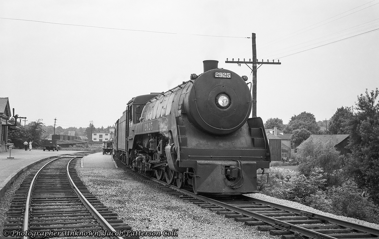 CPR train 640 from Goderich is seen paused at Guelph behind F1a Jubilee 2925 during the summer of 1954.  Less than a year remained for this train, and its counterpart, train 637, which made their last runs on April 23, 1955.  In the background, boxcars can be seen spotted along Cardigan Street near the Pratt Food Company building (formely Goldie Mill).  Silos for the Kloepfer Coal Company can be seen above the boxcars.Original Photographer Unknown, Jacob Patterson Collection Negative.