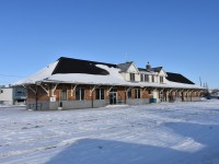 <b> Sounds like The Pas, but feels like The BRRRR! </b> <br>
If it wasn't for the sun shining I likely wouldn't have ventured outside in The Pas, MB in the middle of March taking railway photos. It was a rather chilly -23C feeling -30C when I started my morning walk to the station, but fortunately it warmed up by lunchtime to a balmy -18C feeling -23C. <br>
The former CN station in The Pas is now shared by VIA Rail Canada (trains VIA 690, 691, 692 & 693 The Hudson Bay) and, The Keewatin Railway Company (trains 290 & 291 The Pukatawagan Mixed). <br>
This trackside view is from a laneway along the Fence Track (PZ89) which runs behind a row of houses fronting onto Bignall Avenue. <br>
During my time in The Pas I had an opportunity to climb aboard 'The Puk' mixed for a tour of the trains equipment. The local KRC supervisor was telling me they were hoping for some updated equipment in the not-too-distant future. Recent photos posted on the internet are suggesting KRC might be receiving that new (refurbished) equipment early in 2024. I'll likely take another trip north to Churchill in the fall of 2024 and will be looking for that updated consist on The Puk.