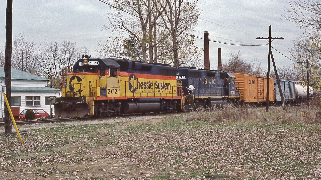 Once upon a time, CSX was a daily weekday appearance.


  Can someone identify this location ?


  Near the CSX Chatham station, October 31, 1991 Kodachrome by S.Danko


  Chessie GP38's, with 2021 and B&O 2008 in this pic, were upgraded from GP38's & GP 38-2's to CSX GP38-3's:between 2014 and 2018


  What's Interesting - per Jerry Doyle's 1999 Chessie System locomotive book: 


 The Chessie System livery had a brief 14 year lifespan: September 1972 to 1986.


 CSX Corporation formed November 1, 1980 as a holdco for Chessie System & The Family Lines (latter to Seaboard System Jan 1, 1983 (from SCL &  L&N)).


  The CSX livery unveiled 1986 and  formal mergers: WM into C&O May 1, 1983; B&O into C&O April 30, 1986 ; C&O into CSX July 1, 1986.
