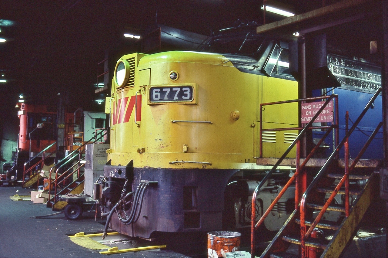 Any Sunday,


Walk into the office,


On the counter was a basket with paper work for Visitors: Sign the Release, grab a hard hat,


Then stroll around...


...like you own the place....


MLW 1959 built FPA-4  VIA #6773 awaits some attention,


in the background a MLW 1960 built RS-18m, permanently assigned & painted for CN Tempo service CN #315x, and leased to VIA.


Inside the CN Spadina roundhouse –  indeed a hallowed place – January 23, 1983 Kodachrome by S.Danko.