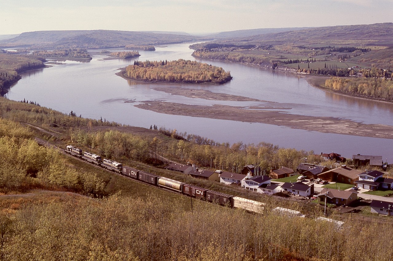 To connect traffic off CN’s Great Slave Lake line from Hay River and Pine Point to the rest of the railway network, Northern Alberta Railways ran a GSL Turn from McLennan to CN’s Roma Junction yard near Grimshaw then back to McLennan, and acquired four SD38-2 units with dynamic braking to handle the grades down to and up from a crossing of the Peace River at the town of the same name.  Here, a trio (typical power on a GSL Turn), 402 + 403 + 401, is well into the ruling grade southward from Peace River heading back to McLennan.