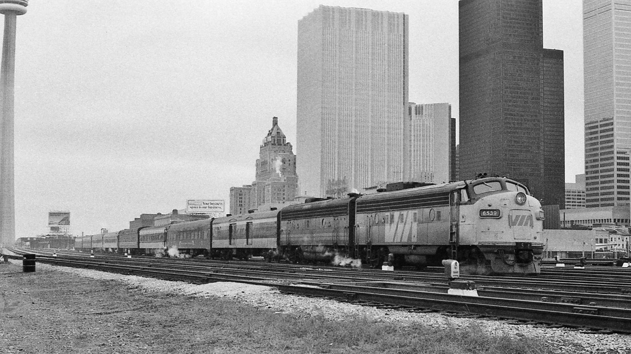 Christmas season Special.


Certainly a different VIA than we are experiencing today...


Early in VIA's tenure management had the railways' cooperation to experiment with services, per passenger demand...


and early VIA had sufficient equipment to add service(s) where deemed necessary....


An eclectic consist it was:


GMD FP7A 6539


GMD F9B 66xx


NSC built Baggage 96xx, CN livery.


Pullman 1941 built ONR Polar Bear Express coach #836 (ex N&W #1733)


CC&F built coach 5200 series, CN livery


CC&F 1930 built heavy weight (88.5 tons) #577 Club Lounge Buffet (club seats 27; lounge 19) series:  Lake Couchiching 


two Budd built 100 series coaches, in CP Rail livery, vestibules forward.


CC&F built 5500 series coach


one sleeping car, CN livery.



VIA Rail #11 'Atlantic' departing Union about noon hour on a very grey Saturday December 22, 1979 Kodak negative by S.Danko.


So sleeping car and coach through service: Toronto to Saint John and Halifax, did happen !


This scheduled Special (hence no white flags / markers) was listed in a supplemental seasonal Timetable (anyone able to confirm?) issued after Thanksgiving, operating eastbound from Union with at least 2 departures: Thursday & Saturday.


Attribute #577's (& sisters 574 - 578) longevity to the CC&F 1930 built car constructed with electro-mechanical air conditioning – a rarity for the time period.


sdfourty