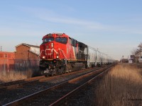 On a typical snowless January day in Hamilton, ON, CN 3236 is pictured leading a short, extra empty grain train with factory-fresh CN hoppers. During this time, CN ran a number of these extras. They were neat because they were unit trains, all the cars were brand-new, and all CN. Unfortunately, this one was shorter than some of the others that ran. 