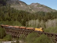 With just two miles to go to reach tidewater at Beaver Cove, a northward train of logs on Canadian Forest Products’ Englewood Logging Division on Vancouver Island is being led downgrade by dynamic brake equipped EMD SW1200 number 4804 across the Elk River timber trestle on Wednesday 1977-04-27.

<p>CFP 4804 (later 304, then in 2006 to Western Forest Products 304) was originally Coos Bay Lumber 1203, then Georgia Pacific 1203, before coming to Canada to join three similar GMD-built units on CFP.  One difference was 4804 had switcher trucks when it arrived and as shown in the photo, but it eventually was converted to Flexicoil trucks like the other three.  After the railway shutdown in 2017, Western Forest Products 301, 302 and 304 were scrapped in 2023, but 303 survives on display at logging headquarters in Woss (https://maps.app.goo.gl/SGRDthxY7EFeCayr7?g_st=im), thirty-seven miles up the Nimpkish Valley from tidewater.