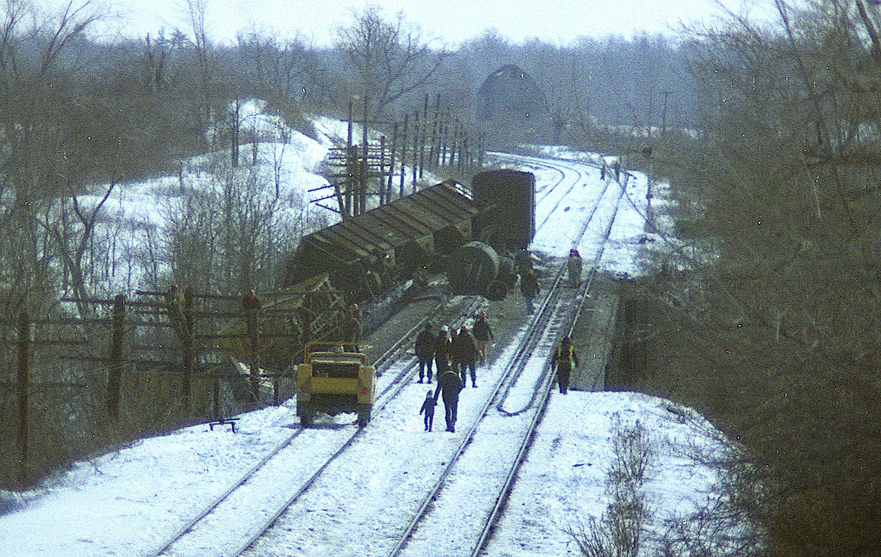 By the look of it a freight running westbound ran into a problem on the bridge over the Grand River at Cayuga. We're looking at a 622 foot bridge at mile 46.38.
I have been unable to find out anything on this derailment and so throwing this shot out to RP in hopes someone can give us the information needed.
Just by chance I happened upon this.
Most of the cars that derailed went off on the north side so I went up the sideroad somewhere (I forget) and did a rather miserable walk over the frozen river and about 6 or 8 inches of snow.....strong wind at my back really did a number on me when I was returning to the car. At least a dozen cars piled down below the bridge.
I'm assuming it was a Conrail train.  Anyone know?  THANKS.