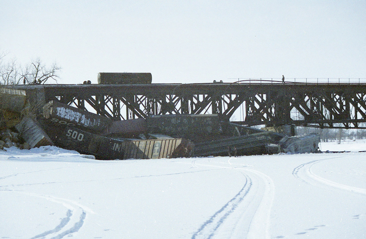 Along with the view taken from the road bridge over the railroad at the Grand River in Cayuga, I'm offering this shot of the mess that piled up when this probably westbound train derailed a few cars into the frozen river. I have no idea why my film developed so poorly from this adventure. Just one of those happenings. But at least one can see the extent of the damage.  I did see a couple of other photographers up near the wreck, but I stayed back.