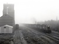 On Friday 1981-09-25, it was foggy in Leoville, SK, as a freight train from Meadow Lake returning to Prince Albert passed the grain elevator at 0848 CST, with a typical trio of RS-23 lightweight (for CN joint use branchline operation) units, 8018 + 8016 + 8015, for power.  34.2 more miles to reach CN rails at Debden, then 31.5+28.7+0.1+0.6 miles on four CN subdivisions (Big River, then Blaine Lake, Duck Lake and Tisdale) to reach CP rails at Prince Albert and a switchback route down to the CP yard, a spider’s web of lines.

<p> From https://www.traingeek.ca/wp/trains/class-1-railways/cp-saskatchewan/meadow-lake/:  “The subdivision was traded to CN in 1987 (?) in exchange for the CN Bengough subdivision. It was taken over by the Carlton Trail Railway in 1997.”  In 2008, decommissioning was announced, and it is now abandoned with the rails removed.