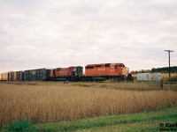 A CP eastbound is viewed departing the siding at Wolverton, Ontario on the Galt Subdivision with SD40-2 5916 and M-636 4709 after meeting a westbound with 5793 and 5513.