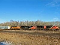 CN 3230 heads east past North Cooking Lake hauling auto racks and empty sand hoppers.
