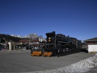 <b> The Mountains and the Mountain Type </b> <br>
The Rocky Mountains tower above Mountain Type steam locomotive CN 6015 that is on static display at the VIA Rail station in Jasper, AB.