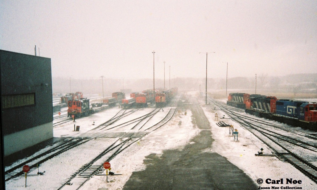 During an early winter snow squall, various units are seen crowding the CN MacMillan Yard diesel facility tracks as viewed through a window of the tower that overlooks the shop area. At the time, a signed release form was all you needed to tour the diesel shop. Dubbed “CN Operations Exploration” it was literally a create your own adventure throughout every visit.
