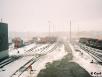 During an early winter snow squall, various units are seen crowding the CN MacMillan Yard diesel facility tracks as viewed through a window of the tower that overlooks the shop area. At the time, a signed release form was all you needed to tour the diesel shop. Dubbed “CN Operations Exploration” it was literally a create your own adventure throughout every visit. 