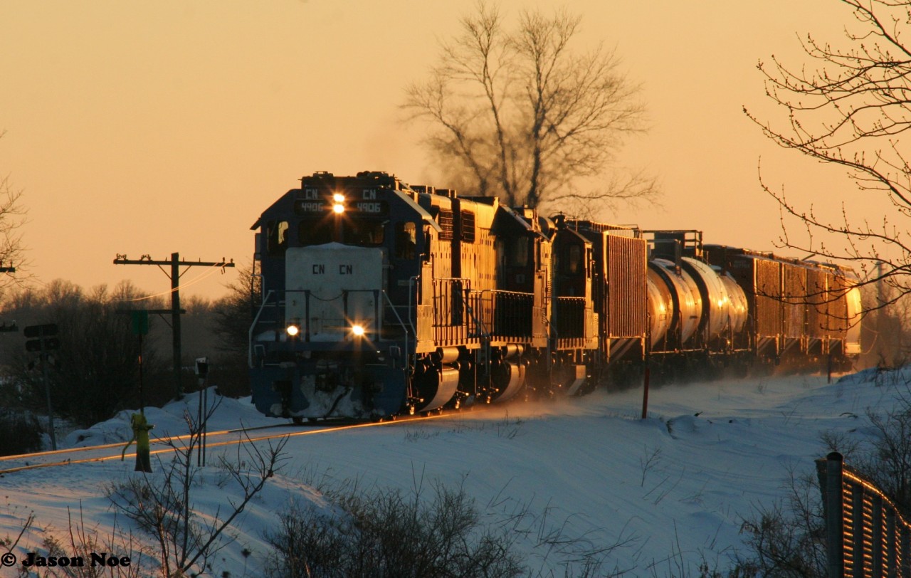 CN 4906 east leads L568 by the west end of the siding in Baden, Ontario as it returns to Kitchener on the CN Guelph Subdivision.