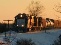 CN 4906 east leads L568 by the west end of the siding in Baden, Ontario as it returns to Kitchener on the CN Guelph Subdivision.