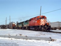 Back when new GO Transit F59PH's had taken over a lot of GO's commuter trains and rendered their older power surplus, some of the rebuilt ex-Rock Island GP40-3 fleet found their way leased to CP for freight service (at least one unit roamed as far west at Alberta). At Woodstock in early February 1992, CP SD40-2 5590 leads GO GP40-3's 724 and 723 on a westbound freight near the west end of the yard, just past Ingersoll Avenue. Both would be traded in to EMD two years later on a <a href=http://www.railpictures.ca/?attachment_id=33769><b>new F59PH</b></a> order, and join the <a href=http://www.railpictures.ca/?attachment_id=43744><b>EMD lease fleet</b></a> in the EMDX 200-series.<br><br><i>Gord Taylor photo, Dan Dell'Unto collection slide.</i>