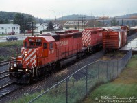 A pair of matching CP SD40-2's, 5651 and 5636, pull into the west end of Chapleau as they arrive with eastbound train #936 on a rainy afternoon. A CP 40' boxcar in OCS service is spotted on a siding near the Monk Street overpass, visible in the distance.
<br><br>
<i>Mike Bannon photo, Dan Dell'Unto collection slide.</i>