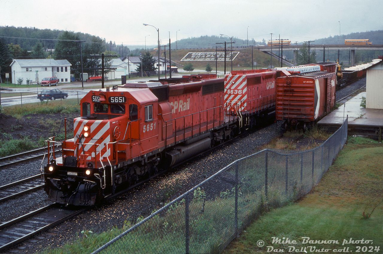 A pair of matching CP SD40-2's, 5651 and 5636, pull into the west end of Chapleau as they arrive with eastbound train #936 on a rainy afternoon. A CP 40' boxcar in OCS service is spotted on a siding near the Monk Street overpass, visible in the distance.

Mike Bannon photo, Dan Dell'Unto collection slide.