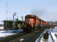 There's no shortage of power on this southbound: CP SD40-2's 5791, 5720, SD40 5526, 5661 and another unknown '40 lead train #300 past the station at Medonte, as the operator gives a wave to the head end crew. The track to the left is the old CP Port McNicoll Sub, that lead to Port McNicoll and Midland via some running rights <a href=https://www.railpictures.ca/?attachment_id=53646><b>over CN's Midland Sub</b></a>. Traffic up front is a sold grain train consist of Canada, Saskatchewan and Alberta government cylindrical covered hoppers.
<br><br>
<i>Peter Jobe photo, Dan Dell'Unto collection slide.</i>