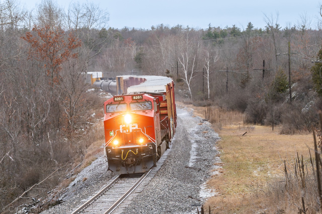 Nicknamed the "dirty 230" by crews. The cushioned drawbars on most cars on a long train leads to a rough start when it gets moving. The daily mixed freight from Bensenville, IL to Montreal St. Luc.
The clearing on the right once held the Christie Lake station back in the day. Now there's not much but some cottages around.