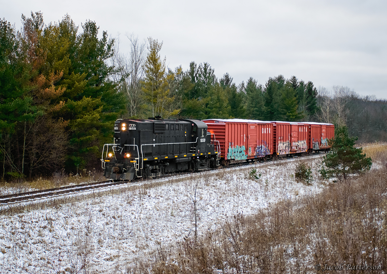 Amid a dusting of snow, GIO Rail 1859 makes its way to St. Catharines with three loads for Clearwater Paper.  They will return straight back to Feeder with three empties; two from the plant and one of the loads seen here.  As only two cars can be spotted at once, the crew waited about an hour for the first car to be unloaded before spotting the other two.