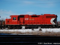 On a cold sunny afternoon in Cambridge, Ontario a CP GP38-2 3128 still has the old Packman logo back in March of 2011.