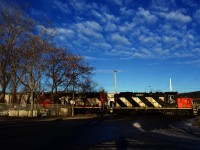 CN 500 is shoving a single plastic pellets hopper towards two box cars for Kruger as it crosses Monk Boulevard. 