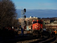CN 322 is passing a couple of foreman working on the North Track of the Montreal Sub on a very cold morning. After setting off cars in Taschereau Yard, CN 322's DPU is quite close to the head end.