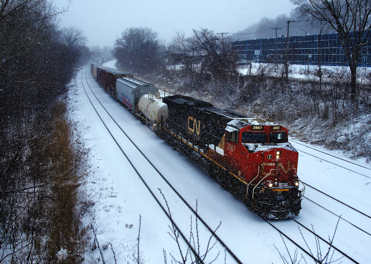 CN 322 is heading towards Southwark Yard on a snowy morning after setting off traffic at Taschereau Yard.