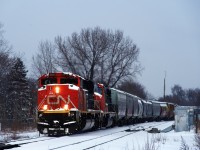 CN 8894 & CN 5641 is the power on CN 527, heading towards Taschereau Yard after working Pointe St-Charles Yard. Here it is crossing from the South Track to the North Track towards the end of a snowstorm.
