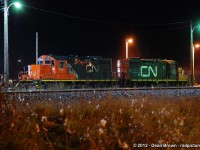 A pair of CN GP9RM 7081 and 7027 idlings in Belleville, ON in Nov 2012.