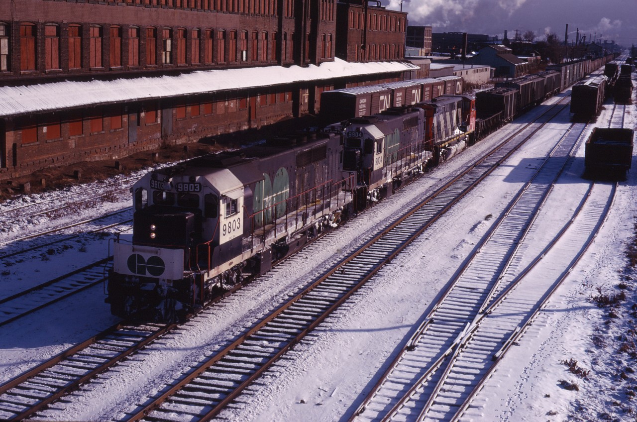 Back in 1973, CN was leasing power while awaiting its GP40-2LWs (deliveries started in March 1974) and receiving GP38-2Ws (delivered from October 1973 to January 1974--source: Canadian Trackside Guide). Here we have GO 9803 and 9804 leading an M420W (delivered earlier that year) through Hamilton on a Sunday morning. GO's GP40TCs were regularly assigned to Fort Erie or Sarnia trains on weekends in the 1970s.