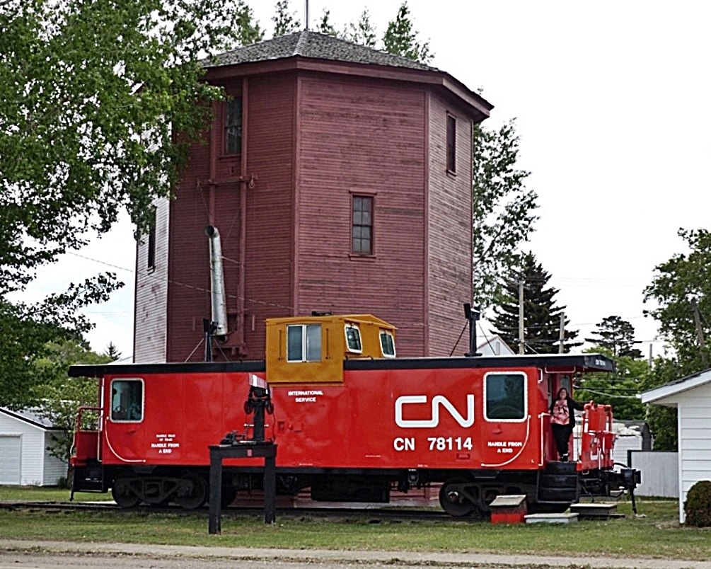 CNR built caboose 78114 along side a water tower at the museum in Harris, Saskatchewan. Built by the CNR in 1934 to plan 150-99, the water tower was designed to hold 40,000 gallons of water.