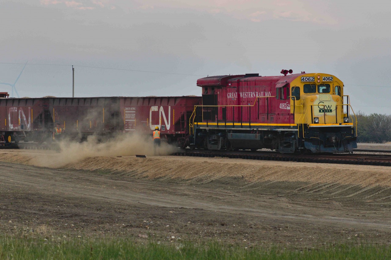 Part 2 of my GWRS Ballast post. Here is their dumping operation at Valour, facilitated by about 2 or 3 foremen trucks worth of ballast crews, which I had essentially followed by accident from the same gas station in Assiniboia. This was actually my first time watching a ballast dumping operation in my life, but I still managed to notice a significant difference between the ballast grades used by Class Is and the type being dumped here: GWRS seems to use a heterogenous mixture of what I believe to be finer sandstones, feldspar-embedded granite, and andesite. Canadian Pacific, on the other hand, accesses a homogenous grade of andesite sourced directly from trackside mines located in Dyment, Ontario on the Canadian Shield or Swansea, BC, in the Rocky Mountains. The relatively small capacity to carry ballast based on GWRS' limited stock of open-top hoppers made the dumping operation finish within an hour of arriving. Then they ran 4062 around and ran southern style back to Horizon to reload from the pit they had compiled there.