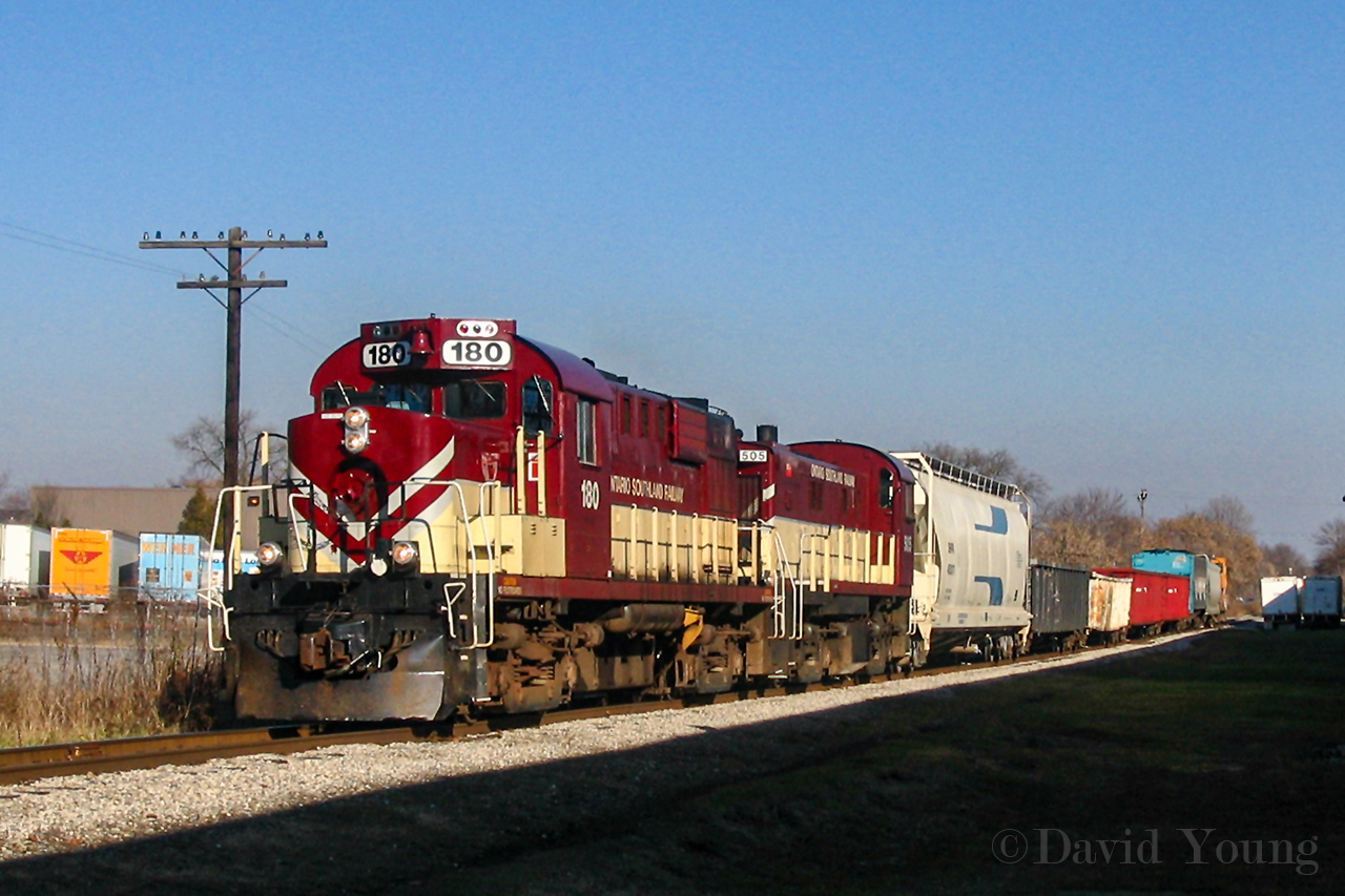 To me it's still hard to believe that the OSR no longer serves the Royal City. To me the OSR and the GJR were interchangeable. Alas, their relationship began to disintegrate and some 22 years after their initial contractual obligation was signed it was over, effective August 28, 2020. I post this view of OSR during their days of grandeur. A late arrival into Guelph with RS-18u 180 and RS-23 505 evade the shadows of the nearby W.C. Wood factory, having just finished servicing the Owens Cornings Fibreglass plant off York Road. They are continuing working their way to Guelph's industrial end, complete with their old CP Angus van. These were the days, vintage power run with a van bringing up the markers. If I only appreciated this sight at the time.