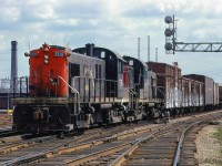 A westbound transfer heads towards the east approach to Union Station with traffic for various industries in the Parkdale neighbourhood along the Weston Sub.  Stock cars and reefers for the stock yards and meat packing plants in the Keele and St. Clair area, and a double deck auto carrier for CN's <a href=https://www.railpictures.ca/?attachment_id=45492>Car-Go-Rail</a> yard at Brock Avenue.  Note the double deck stock car for pigs or other small stock.  The train director at Scott Street Tower will line the movement through the Union Station bypass tracks, and the train director at John Street Tower will line it onto the Weston Sub.<br><br><i>Scan and editing by Jacob Patterson.</i>