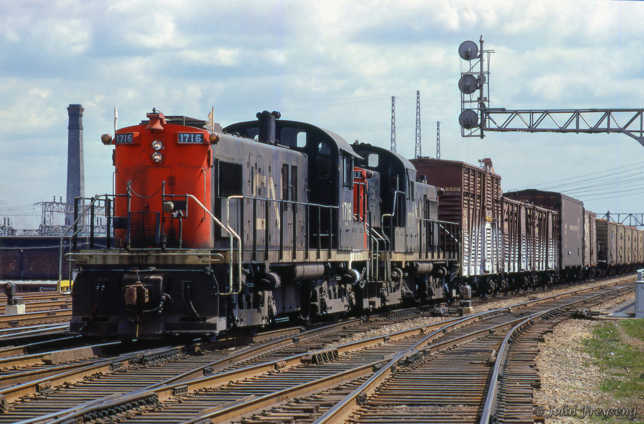 A westbound transfer heads towards the east approach to Union Station with traffic for various industries in the Parkdale neighbourhood along the Weston Sub.  Stock cars and reefers for the stock yards and meat packing plants in the Keele and St. Clair area, and a double deck auto carrier for CN's Car-Go-Rail yard at Brock Avenue.  Note the double deck stock car for pigs or other small stock.  The train director at Scott Street Tower will line the movement through the Union Station bypass tracks, and the train director at John Street Tower will line it onto the Weston Sub.Scan and editing by Jacob Patterson.