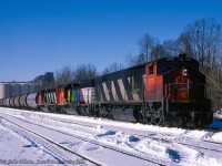 CN train 888 is seen getting its train together on the east side of Midland at Tiffin yards near Tiffin #2 elevator.  The three six-axle units, a BBD HR-616 and two GMD SD40-2Ws, will have easy work of the grain traffic out of the harbour, but will be put to work after lifting stone traffic from the <a href=https://www.railpictures.ca/?attachment_id=52839>Uhthoff Quarries.</a>  Just over a year remains for grain traffic over the line, which once carried grain tonnage east to Lindsay and on to Belleville for points east.  The "at-and-east" grain subsidies cancelled in 1989 resulted in the closure of Tiffin (in 1989) and other lake great lakes elevators.  Note trailing unit CN 5334, the only unit painted into Expo '86 colours.<br><br><i>Peter Jobe Photo, Jacob Patterson Collection.</i>