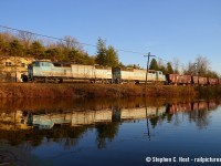Reflected in the pond at Campbellville, a pair of repainted SD40-2f's power a ballast train back toward Toronto Yard. These things came by quite often for a year or two after the June 2020 purchase of the CMQ and haven't really been seen much since.