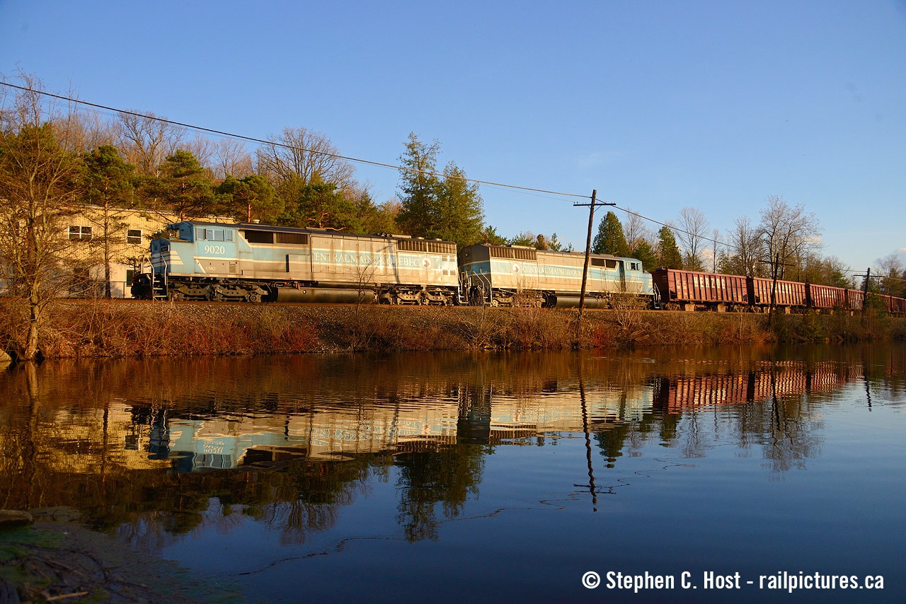 Reflected in the pond at Campbellville, a pair of repainted SD40-2f's power a ballast train back toward Toronto Yard. These things came by quite often for a year or two after the June 2020 purchase of the CMQ and haven't really been seen much since.