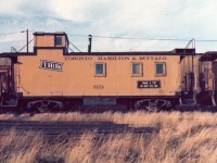 <b> The weed killer is working </b> <br>
It's a hot and windy 1974 summer day as evidenced by the very dry, dead, and leaning tall grasses as I walk around the TH&B Aberdeen Avenue yard in Hamilton, ON. <br>
TH&B 69 sits idle waiting for its next assignment, and sporting a greeting for the crew 'TAKE A TIP. BE SAFE THIS TRIP'.