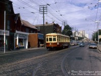 After restoration in 1973 for Tour Tram service downtown, the TTC's small group of Peter Witt streetcars (2424, <a href=http://www.railpictures.ca/?attachment_id=47439><b>2766</b></a>, and <a href=http://www.railpictures.ca/?attachment_id=53292
><b>2894</b></a>) also became popular for fantrip charters. Here, TTC "small witt" 2766 is posed southbound on Parliament at Dundas. Unlike today, paving stones could still be found around streetcar intersections.
<br><br>
Present day, this strip along Parliament remains largely unchanged, and even Bob's Variety still exists at the same location (now as Bob's Convenience). 
<br><br>
<i>Tom Gascoigne photo, Dan Dell'Unto collection slide.</i>