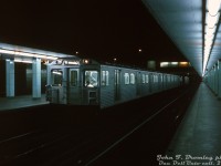 In the wee hours of the night, John Bromley was on the prowl around the deserted platforms of the TTC's Davisville Subway Station and caught a train of brand new Hawker Siddeley H1 subway cars testing on the Yonge line, with H1's 5346, 5347, 5350 and 5351 making up this 4-car consist. The train is sitting at the southbound platform of Davisville Station, with Davisville Shops visible in the background (an old Gloucester subway car can be seen inside). John probably had his tripod set up for the photo, as the slide mount notes this shot as a 1 second exposure at F4, with a 35mm lens (on Kodachrome, of course). <br><br> At the time, the 164 new H1 subway cars from Thunder Bay were still <a href=http://www.railpictures.ca/?attachment_id=36389><b>being delivered</b></a> to Greenwood Yard (a report from John in the UCRS newsletter states 46 of the 5336-5499 order was on the property at the time). Crews were undergoing training and testing on them, and 14 cars so far had been assigned to Davisville Yard including 5346-47 and 5350-51. The first H1 train had entered revenue service on July 26th, and the plan was to have a number of H1 trains based out of Davisville in revenue service on the Yonge line until the new Bloor-Danforth line they were purchased for opened in February of next year (there would be a glut of subway cars in the fleet until then, allowing some G's and M1's to be sent to Greenwood for repairs and other work). <br><br> The H1 fleet was followed up by successive H-series orders over the years, and remained in service for three decades until retirement and replacement by new <a href=http://www.railpictures.ca/?attachment_id=1797><b>Bombardier T1</b></a> subway cars in the mid-late 90's. <br><br> <i>John F. Bromley photo, Dan Dell'Unto collection slide.</i>