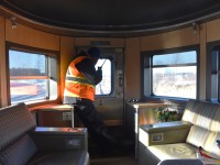 <b> Okay to come back 25 more! </b> <br>
VIA 001 The Canadian is making its reverse move through CN Snider, ON with the tail end protection person diligently monitoring the movement. <br>
This view from inside VIA 88709 Laurentide Park on December 12, 2021 has the pilot, with radio in hand, sitting on the rear corner table, which houses the emergency air brake valve. <br>
I'm looking forward to getting back on VIA 001 The Canadian one week from today for another cross-Canada and return trip. :-)