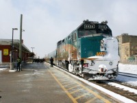 With obvious signs of battling snow drifts to the west, VIA Rail #84 with 6426 is viewed pausing to load a full platform of passengers at the Kitchener, Ontario station. 